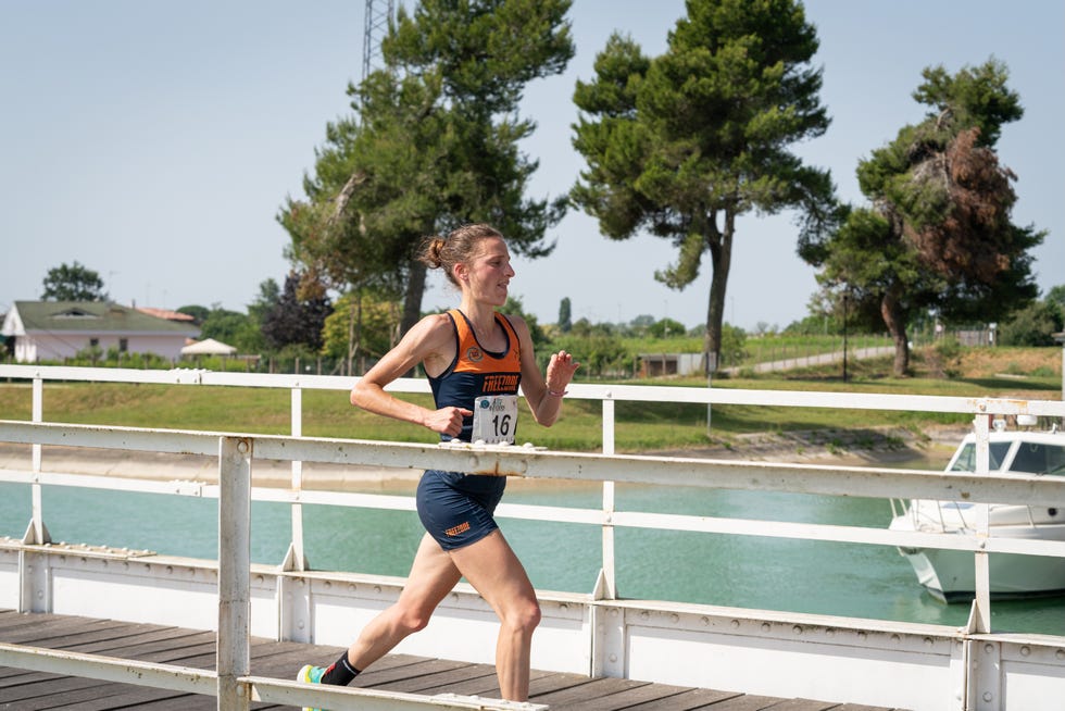 runner on a bridge near water