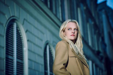 fashionable figure wearing a stylish coat against an urban backdrop