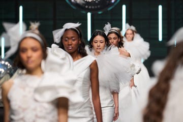 a group of women wearing white robes and hats