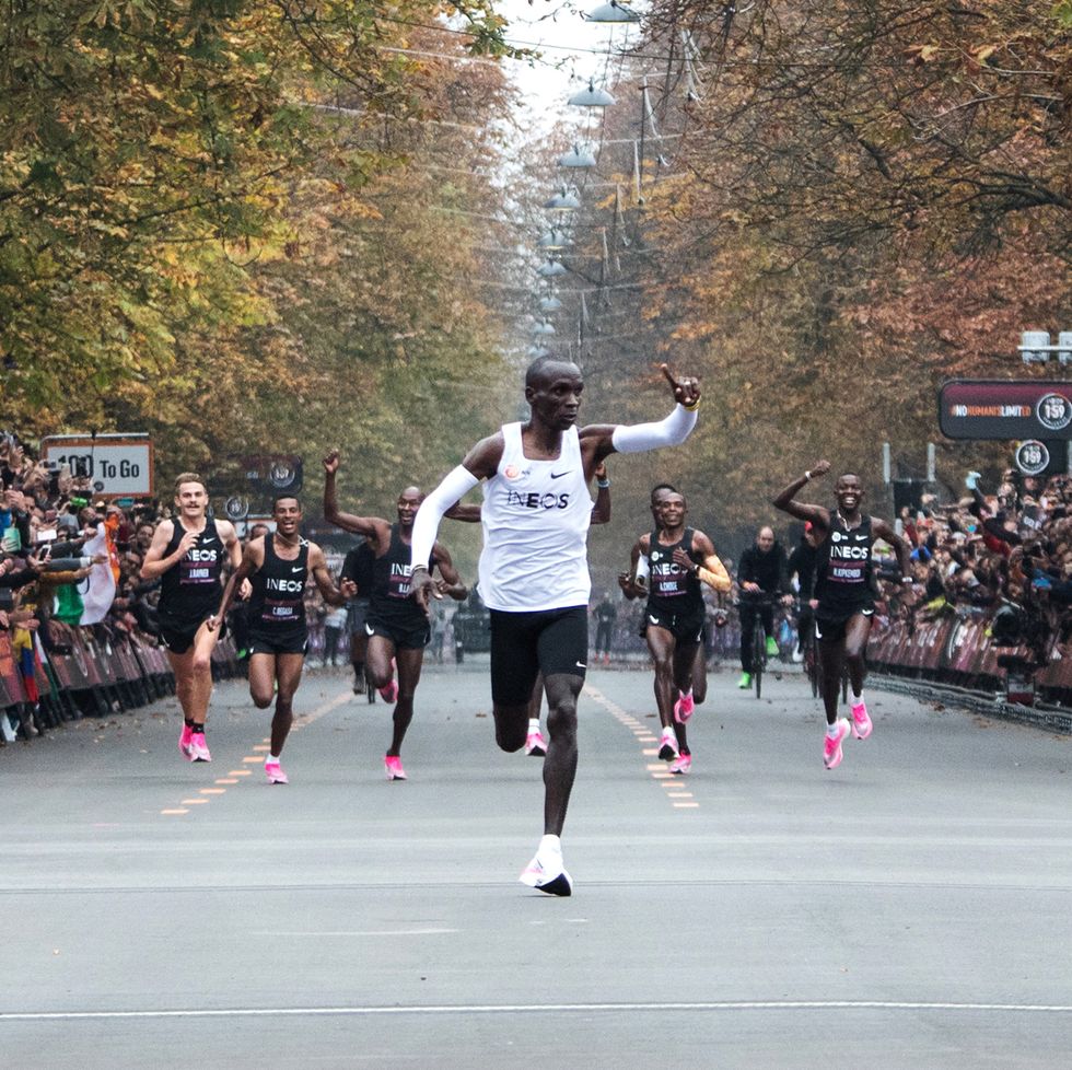 eliud kipchoge celebrates while running in vienna in a white nike singlet