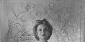portrait of canadian born beautician and cosmetics entrepreneur elizabeth arden 1878 1966 dressed in a ball gown as she clasps her hands together and stands in front of a framed piece of art, 1947 photo by hulton archivegetty images