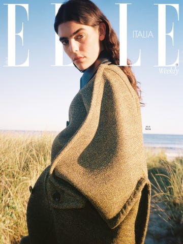 fashion magazine cover featuring a model in a stylish outfit against a beach background