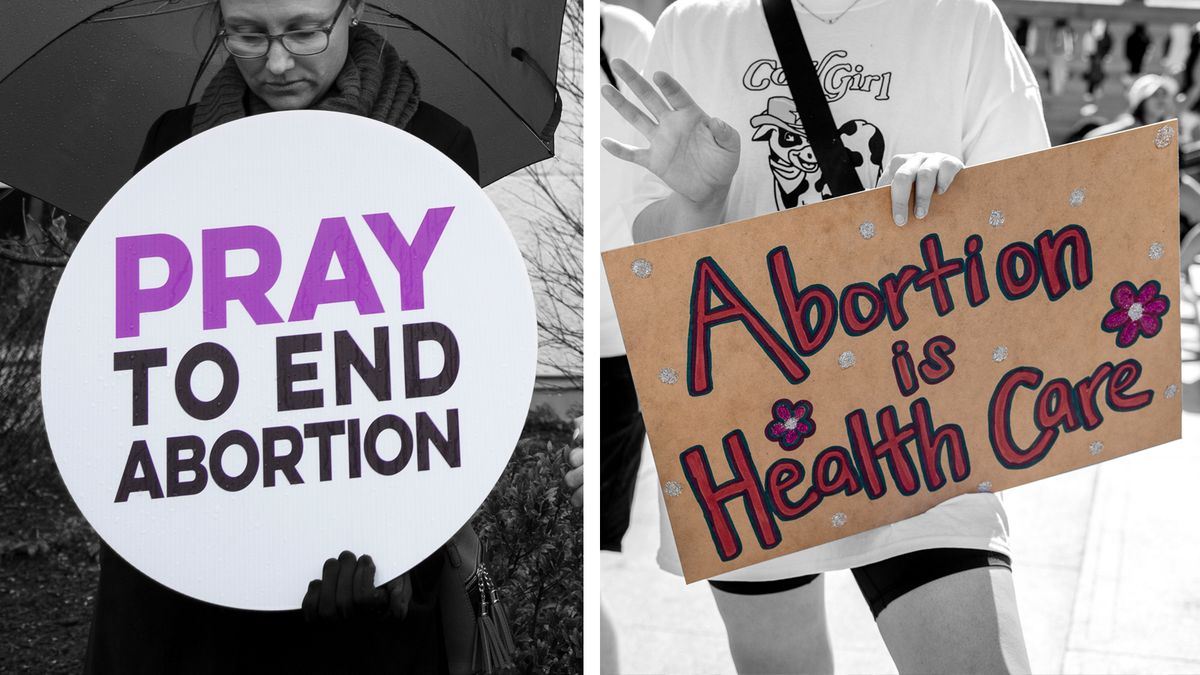 one protest sign on the left that reads pray to end abortion and one on the right that reads abortion is health care
