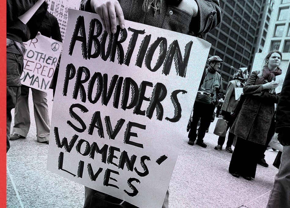 a rally participant holds a sign that reads "abortion providers save womens' lives" during an international women's day march in chicago