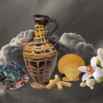 a water pitcher surrounded by shells, flowers, palo santo