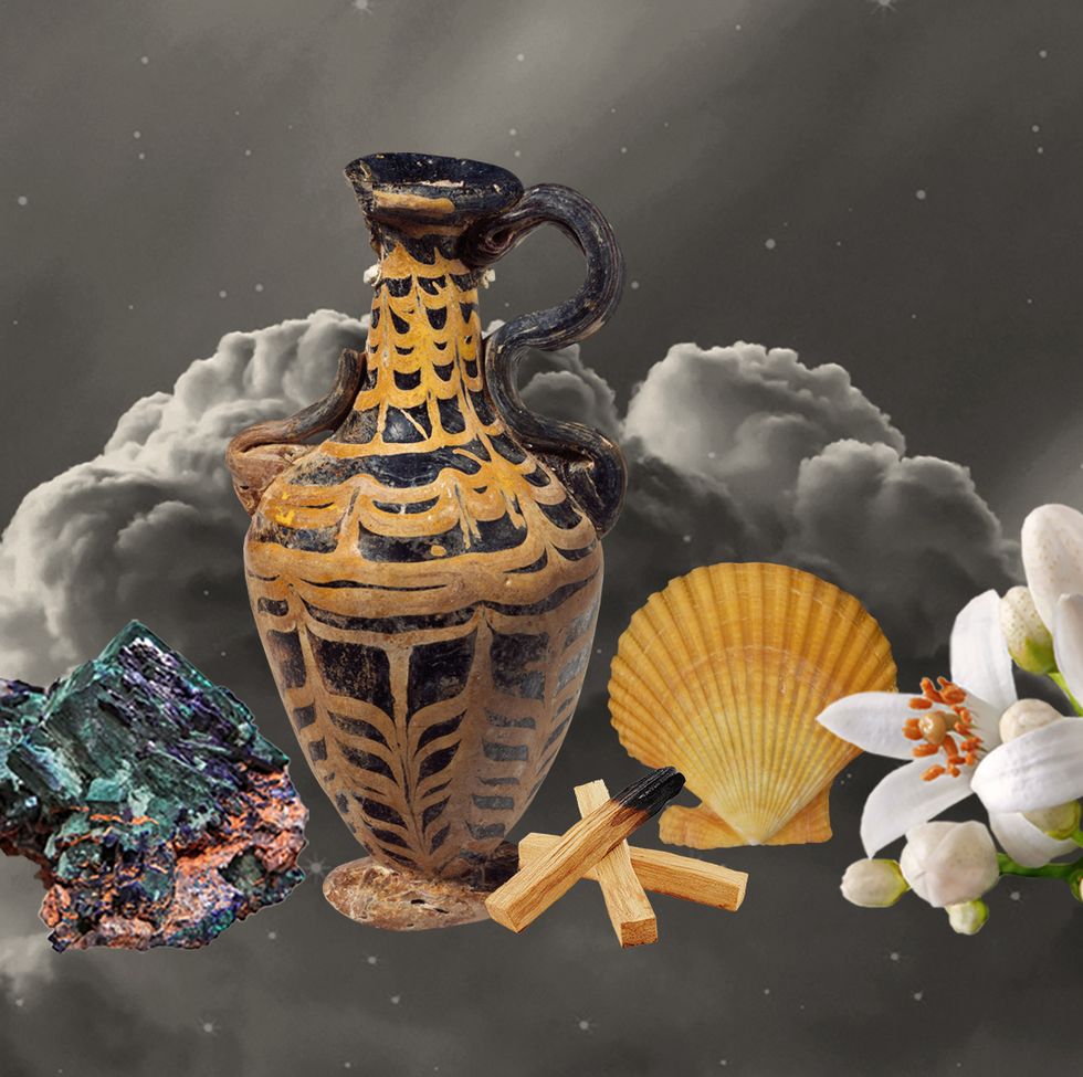a water pitcher surrounded by shells, flowers, palo santo
