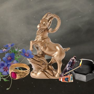 a statue of a ram surrounded by flowers, a ring, matches