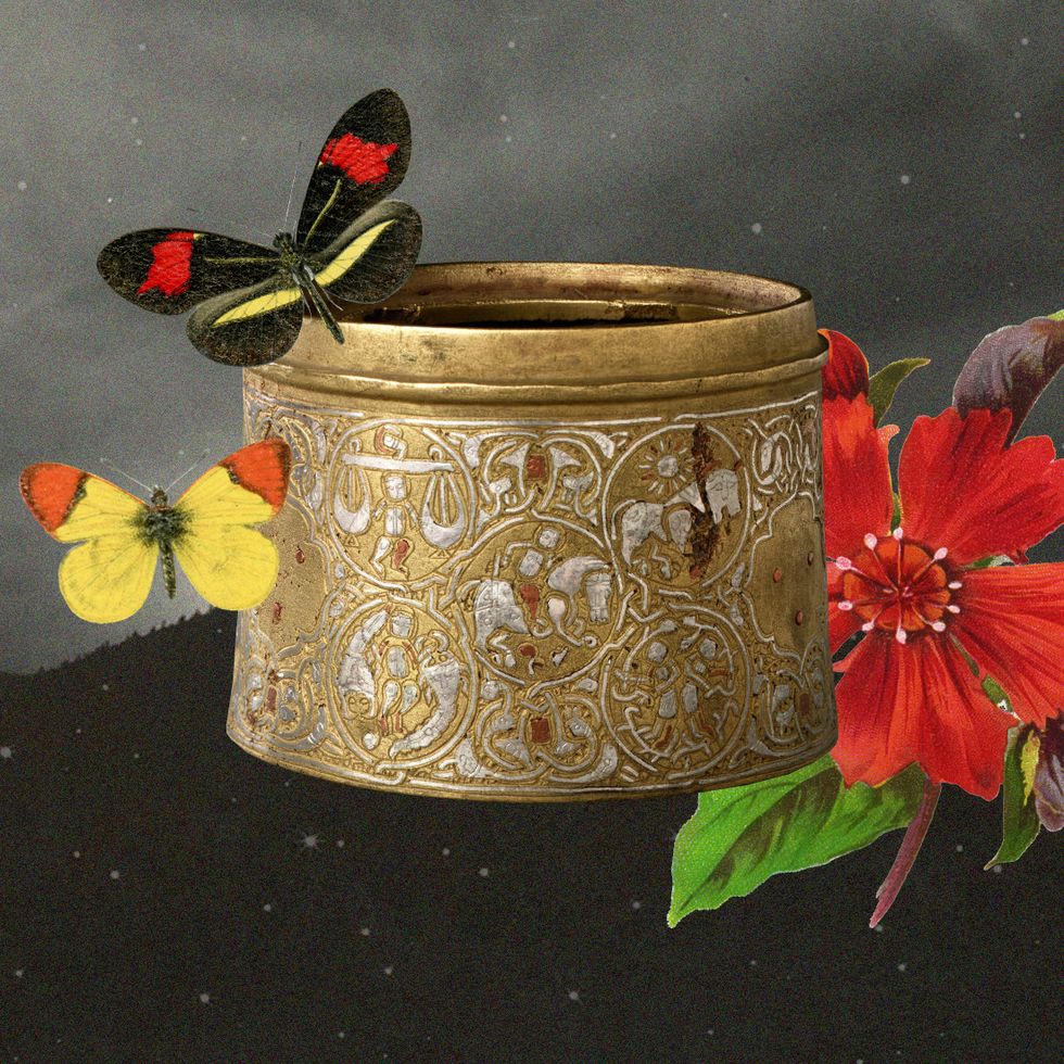 a vase with flowers and butterflies