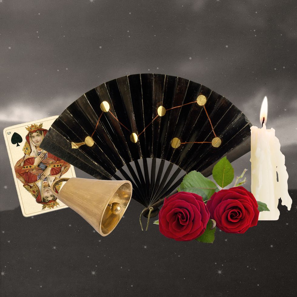a gold and black fan with a couple of roses and a couple of cards