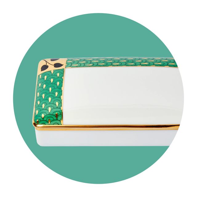 a white and gold box with green patterns