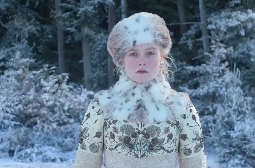 person in winter clothing standing in a snowy forest