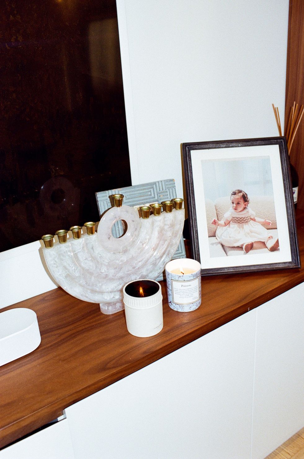 a picture frame and candles on a table