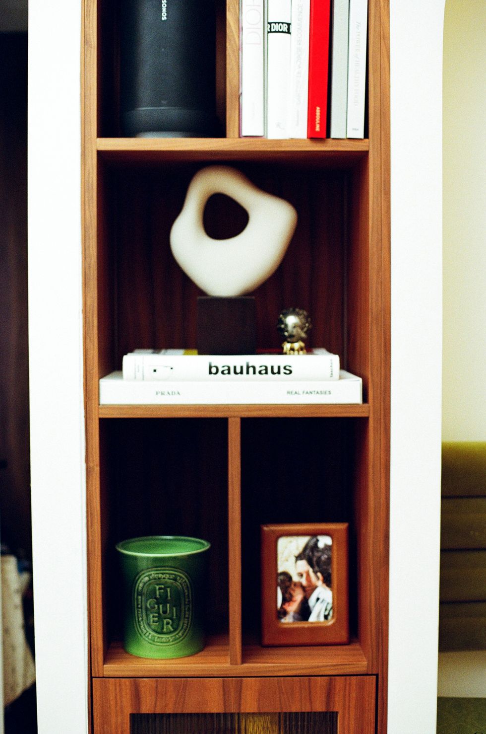 a shelf with books and a can