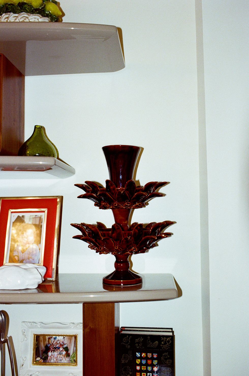 a vase with red flowers on a table