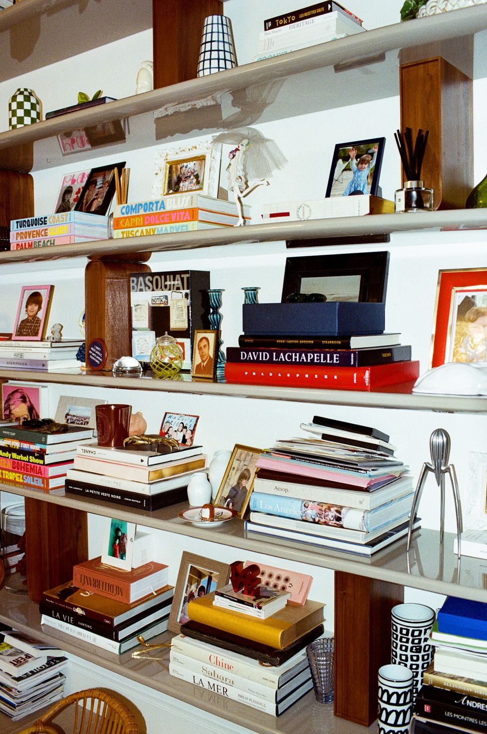 a shelf with books and pictures on it
