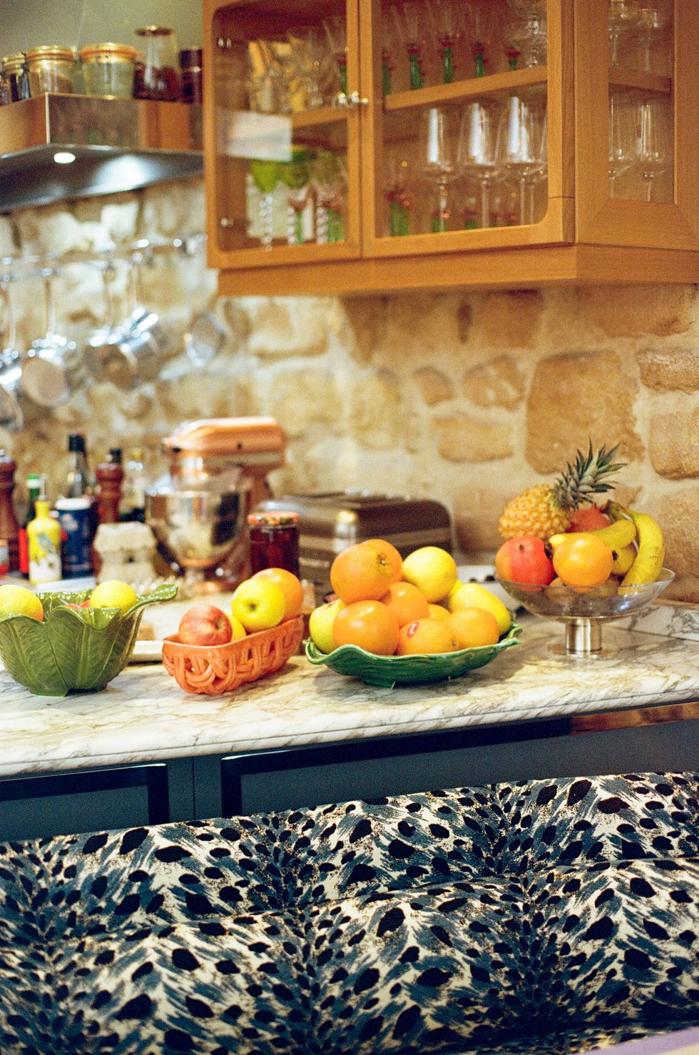a kitchen counter with fruits and drinks