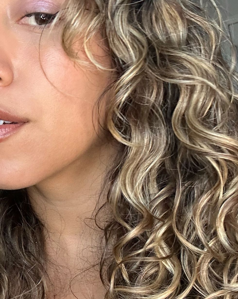 a woman with blonde curly hair