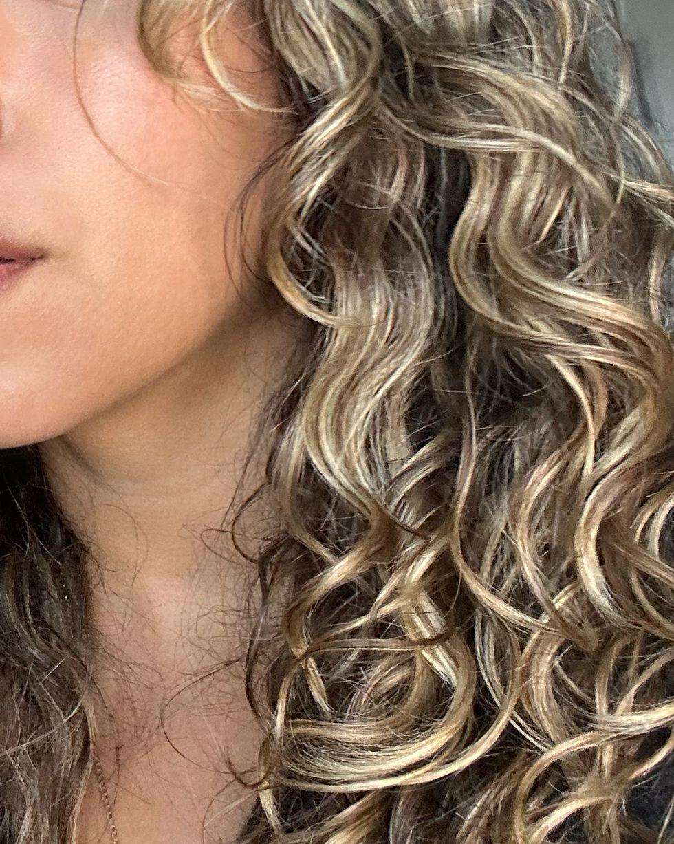 a woman with blonde curly hair