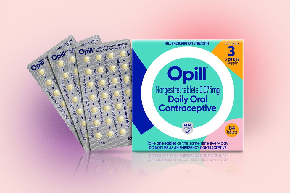 a box of opill set against a pink and purple background