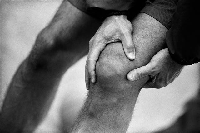 Man Holding Knee