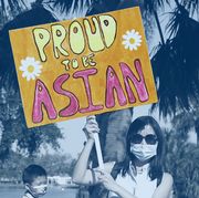 a woman shows a sign that reads proud to be asian during a rally against anti asian hate crimes