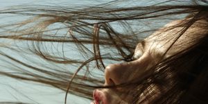Caucasian woman with hair blowing in wind