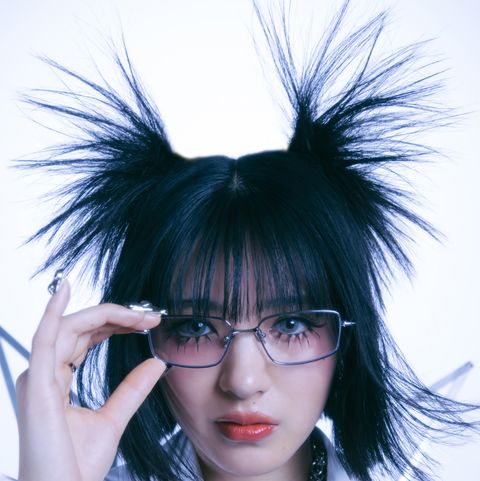 a woman with black hair and glasses