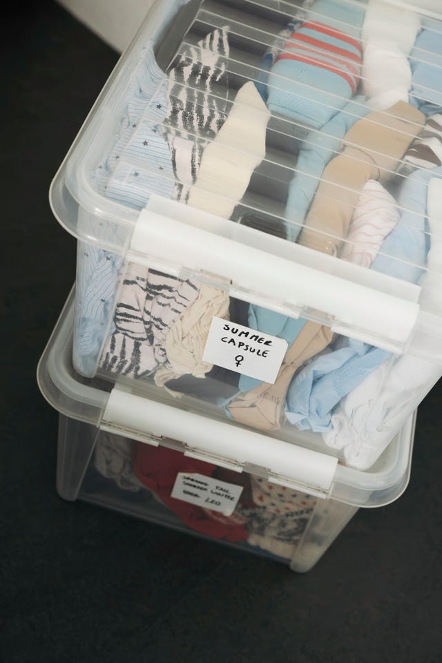 Transparent plastic bins filled with clothing