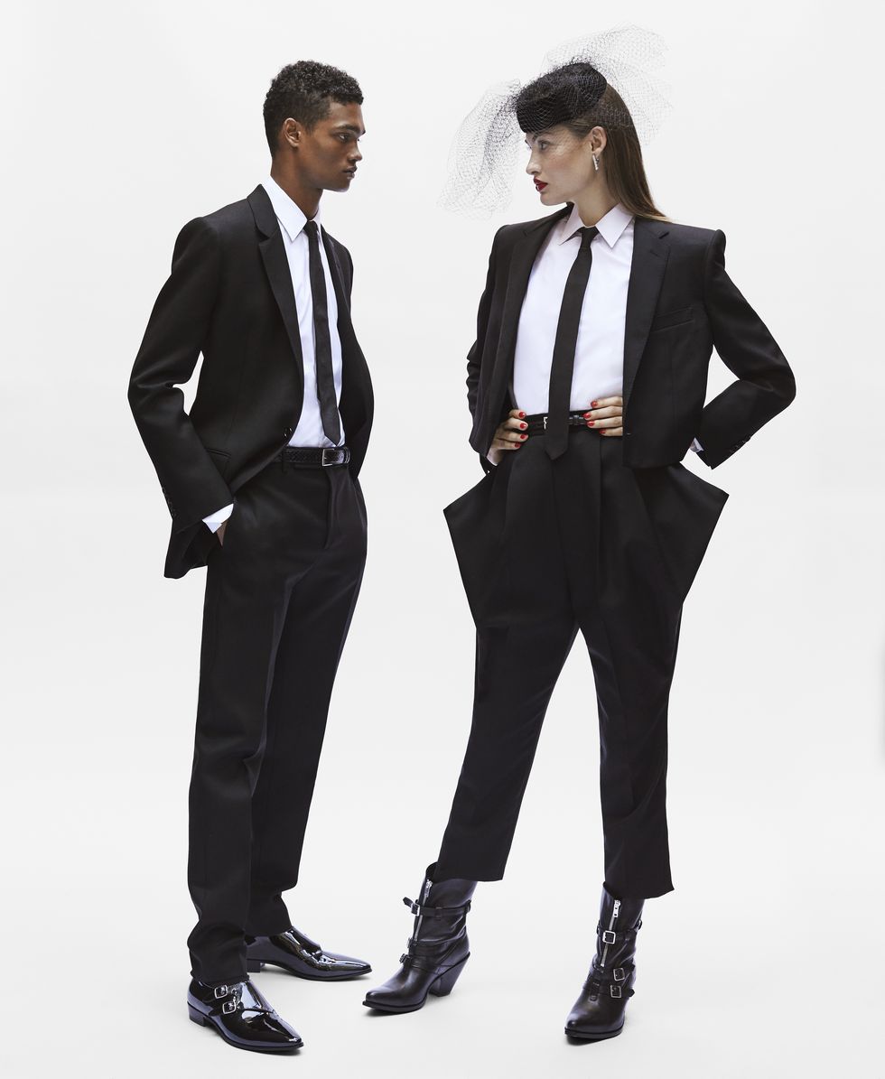 Suit, Clothing, Formal wear, Standing, Tuxedo, White-collar worker, Outerwear, Tie, Blazer, Uniform, 