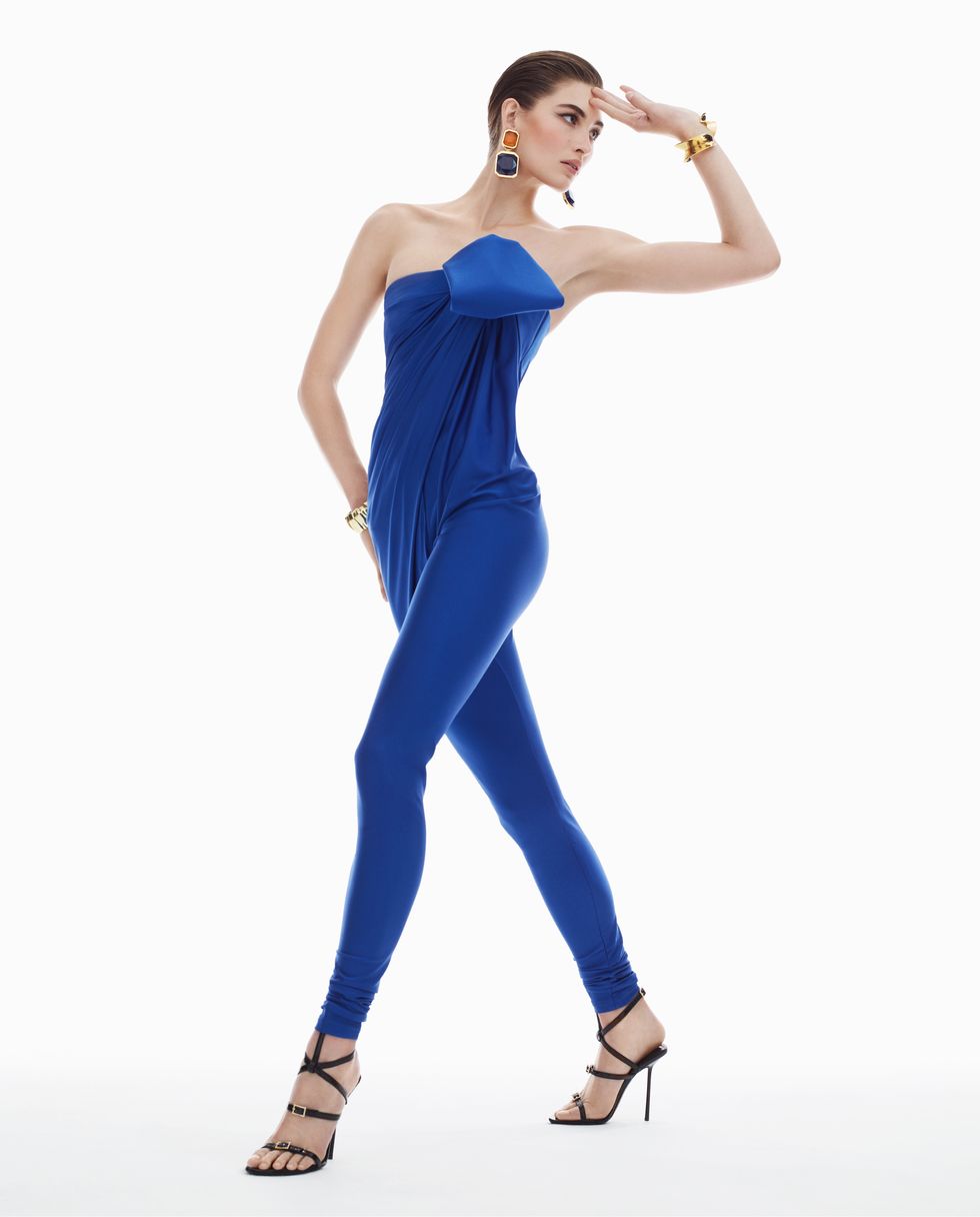 model grace elizabeth wears a royal blue catsuit and jewels