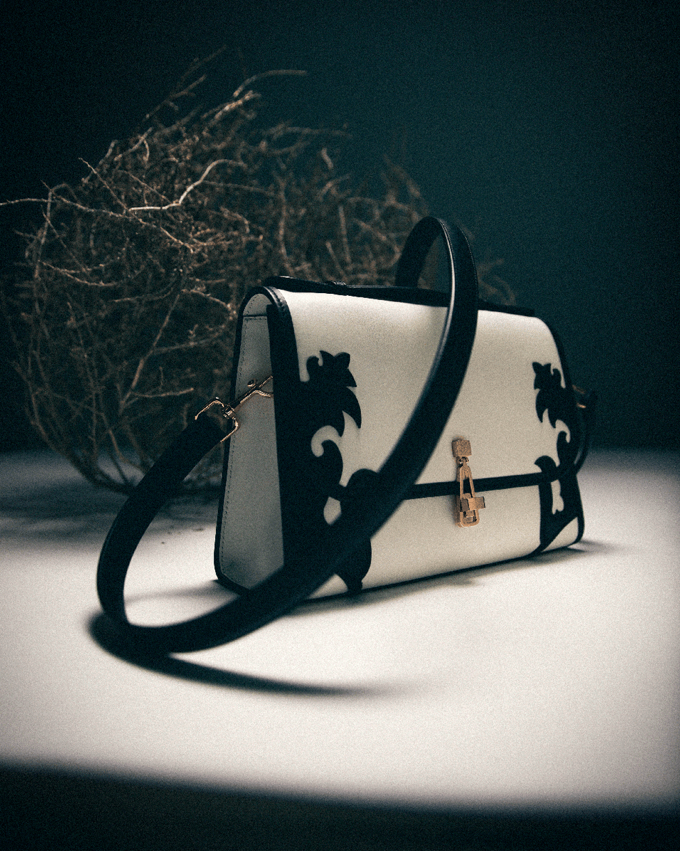 black and white handbag with intricate western design elements