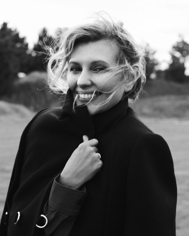olena zelenska wears a black cape coat outside