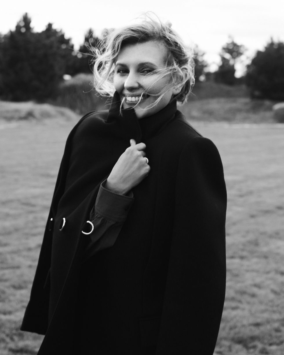 olena zelenska wears a black cape coat outside