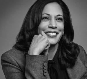 vice president kamala harris smiling with her hand on her chin