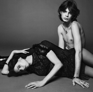 a female model lying down and a male model sitting up
