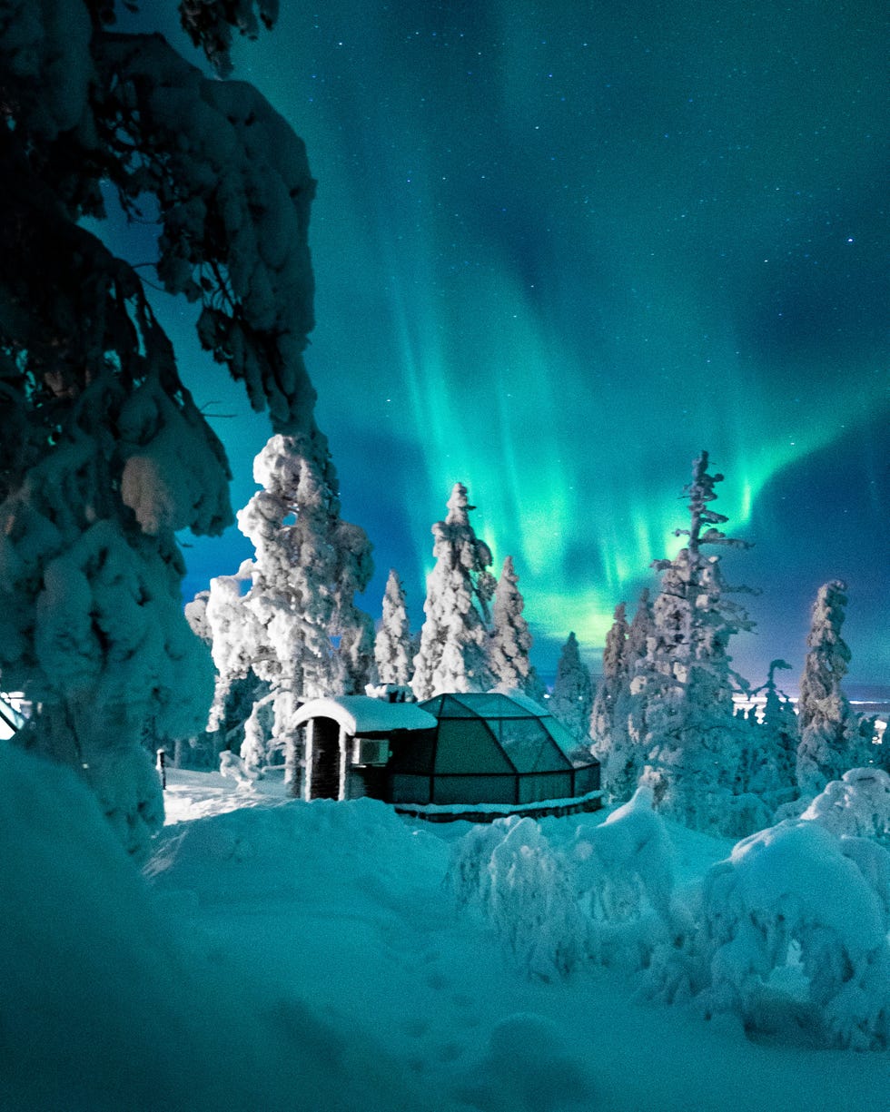 at finland’s levin iglut resort, travelers ﻿can curl up in bed under a glass dome ﻿to watch the northern lights