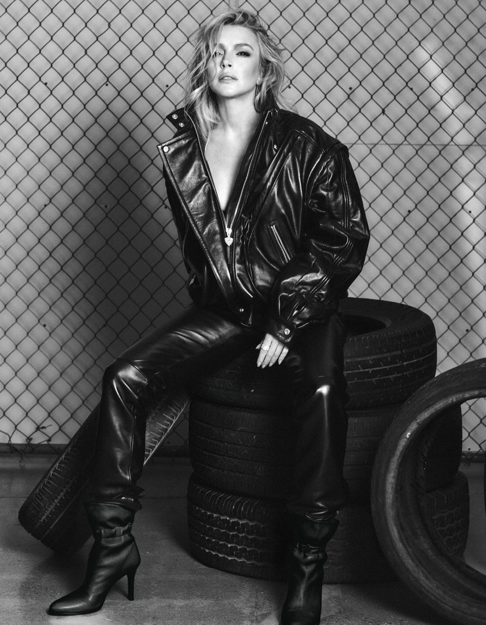 lindsay lohan sitting on a stack of tires