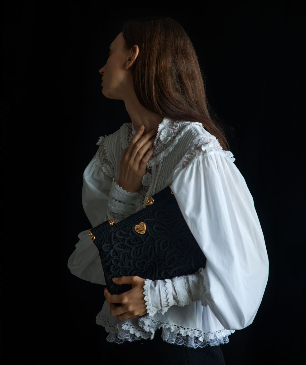 woman in blouse with purse