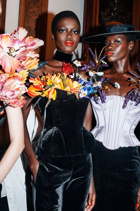 two black women wearing flower embellished corset ensembles