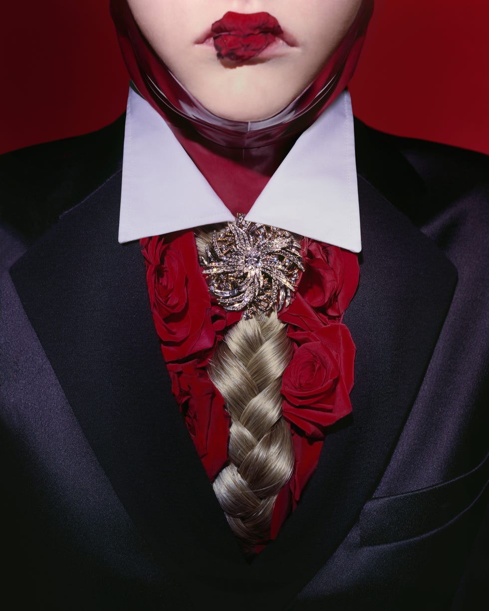 a close up shot of a woman with a tie made of braided human hair