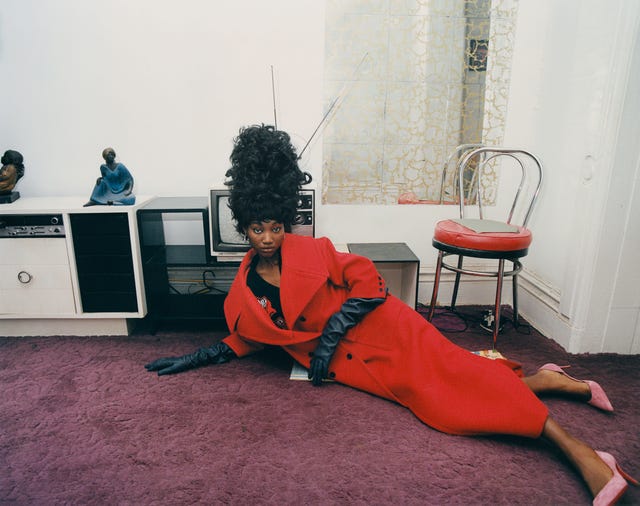 a person laying down with a tv and chair in the background