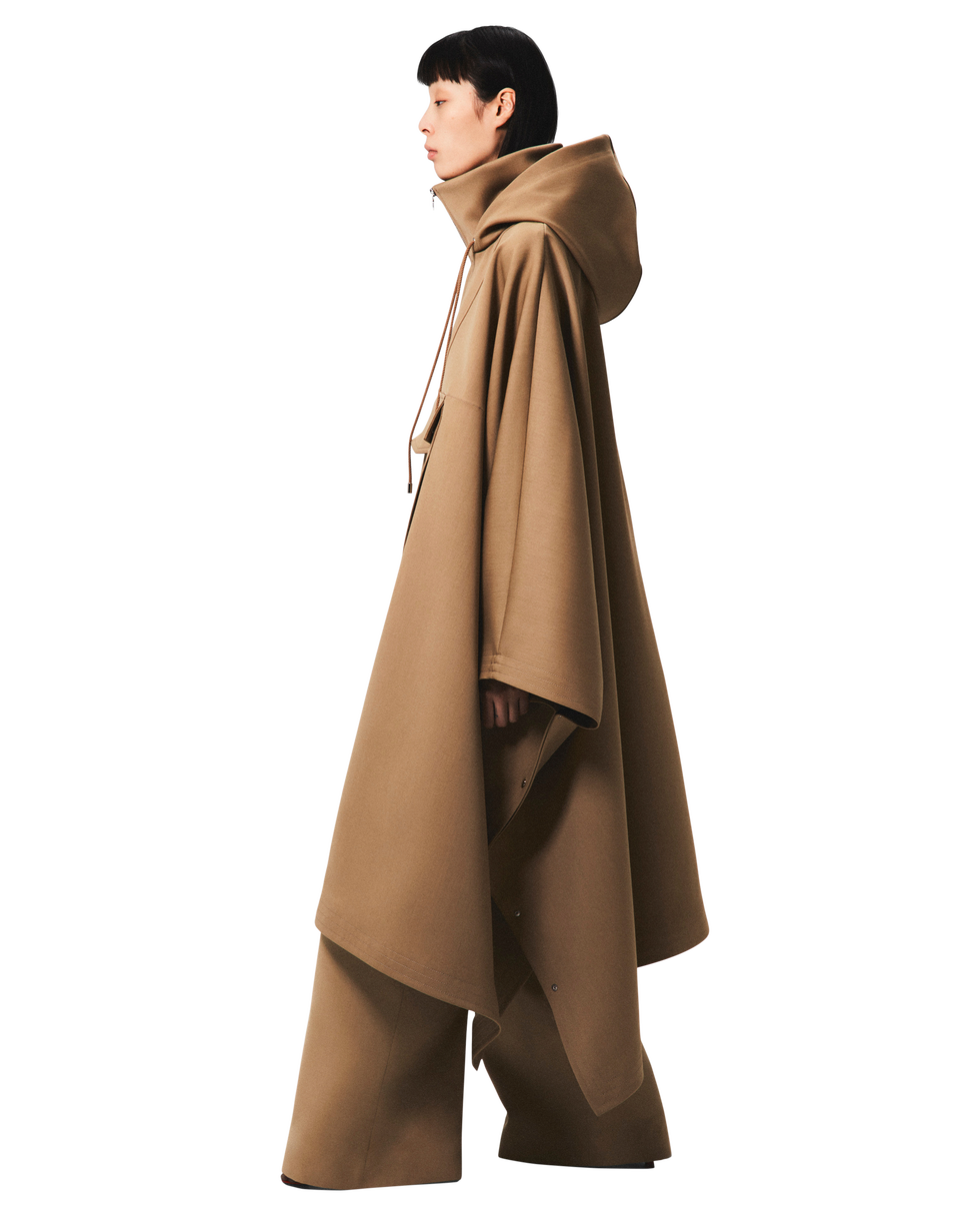 adam lippes fall 2024 a woman wearing a tan caped coat