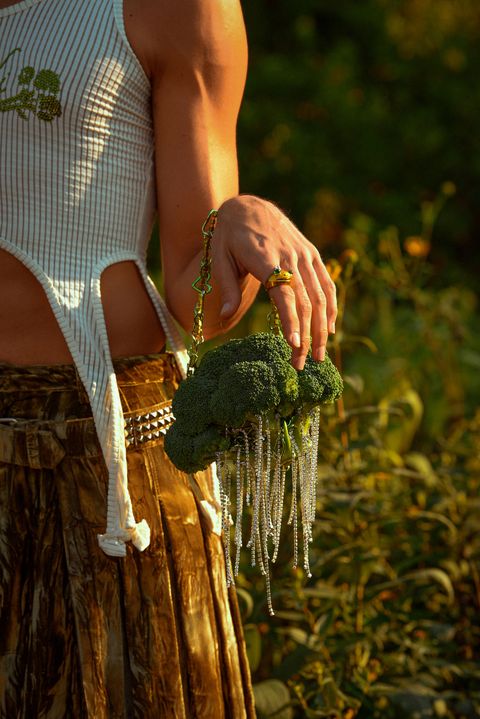 a model holds a broccoli shaped bag