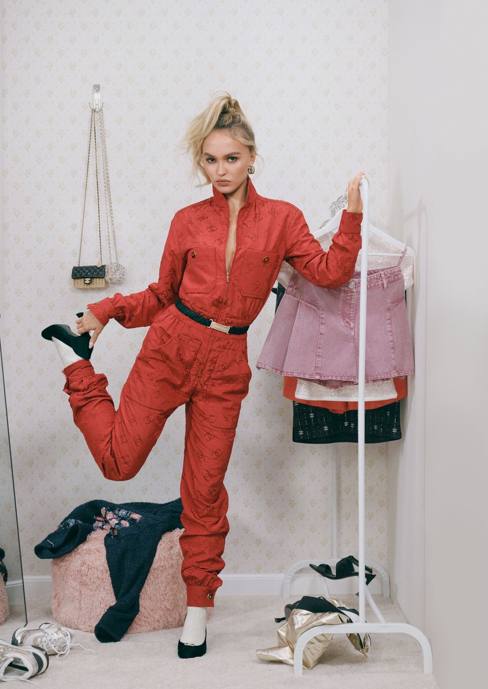 lily rose depp poses in a red jumpsuit