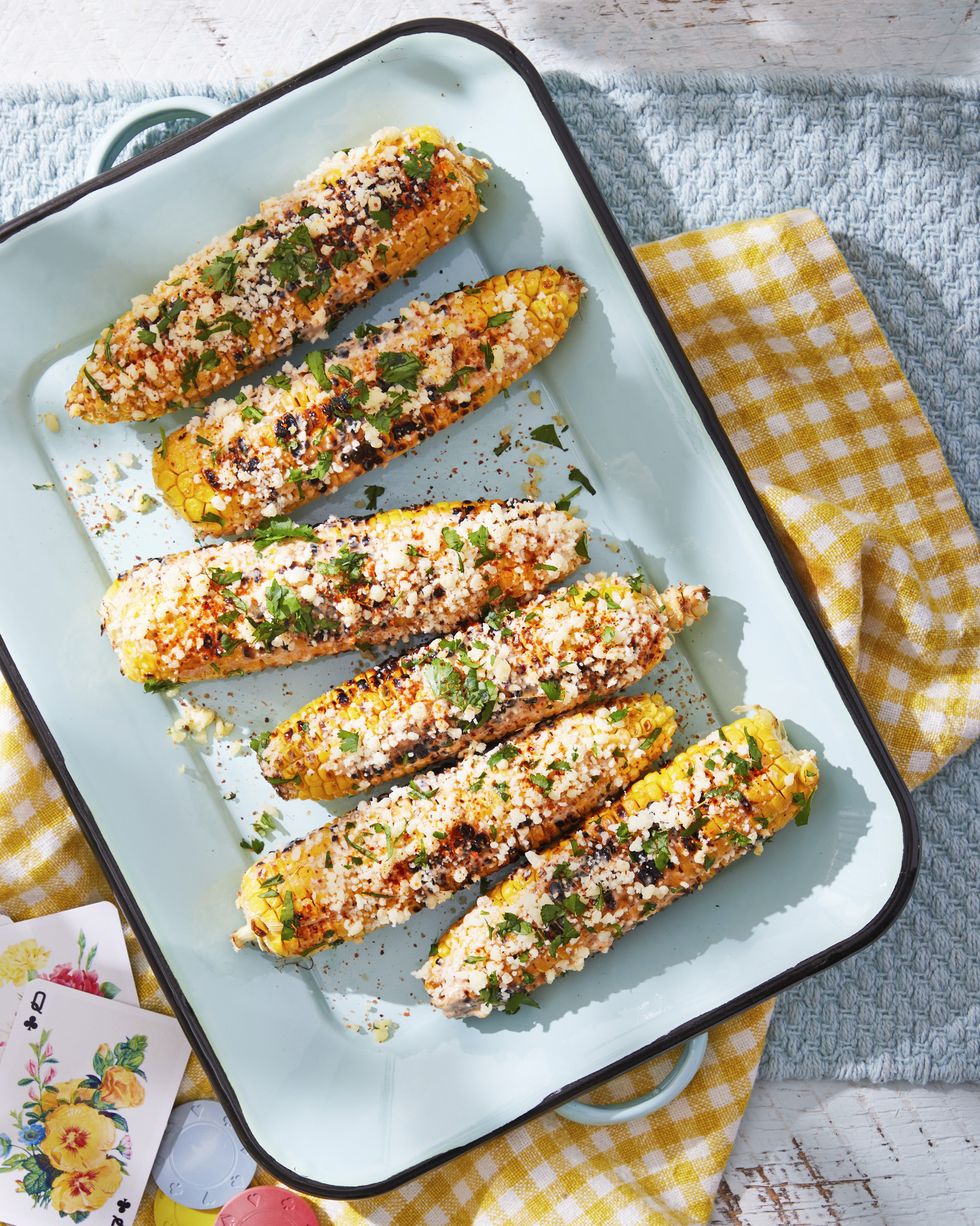 elotes mexican street corn covered in cheese and herbs on a platter