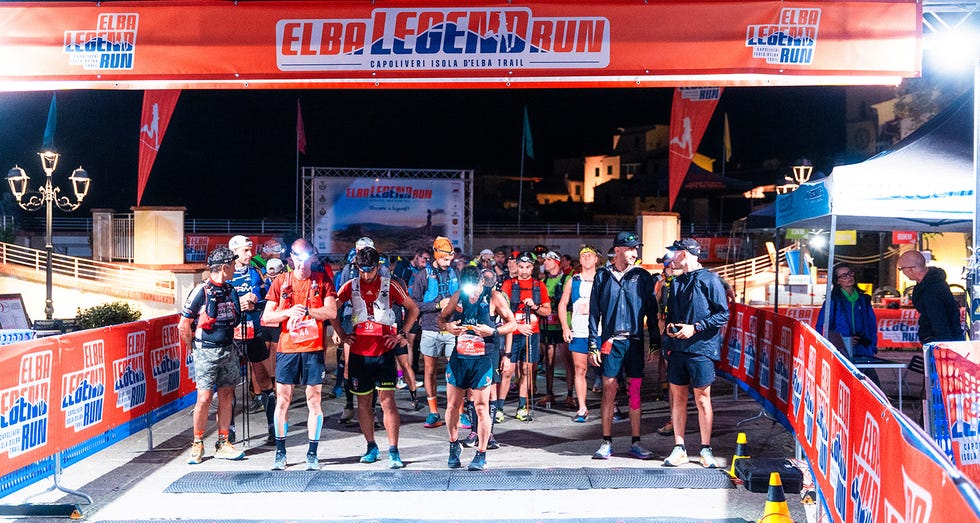 starting line of a running event with participants and banners