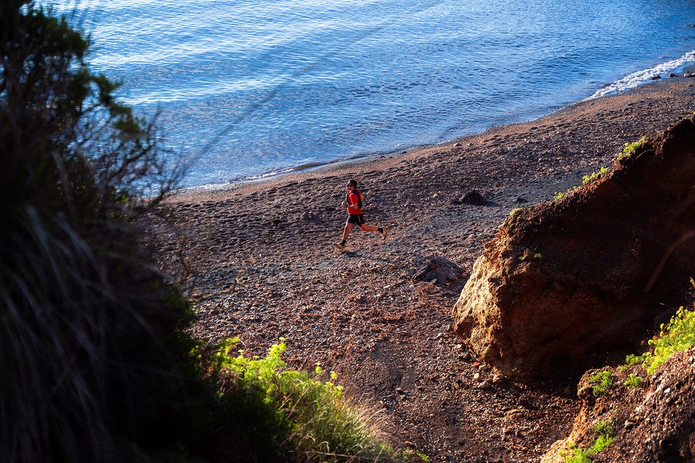 runner exercising along a coastal beach