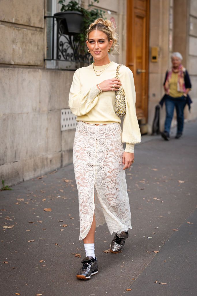 Street Style Todas Las Zapatillas Que Son Tendencia   Emili Sindlev Wears A Yellow Sweater Cream Lace Midi Skirt News Photo 1696669172 