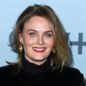 emily deschanel in a black dress with big gold earrings at an apple tv event