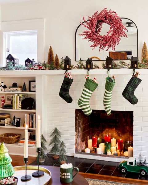 fireplace mantel with stockings and bottle brush trees